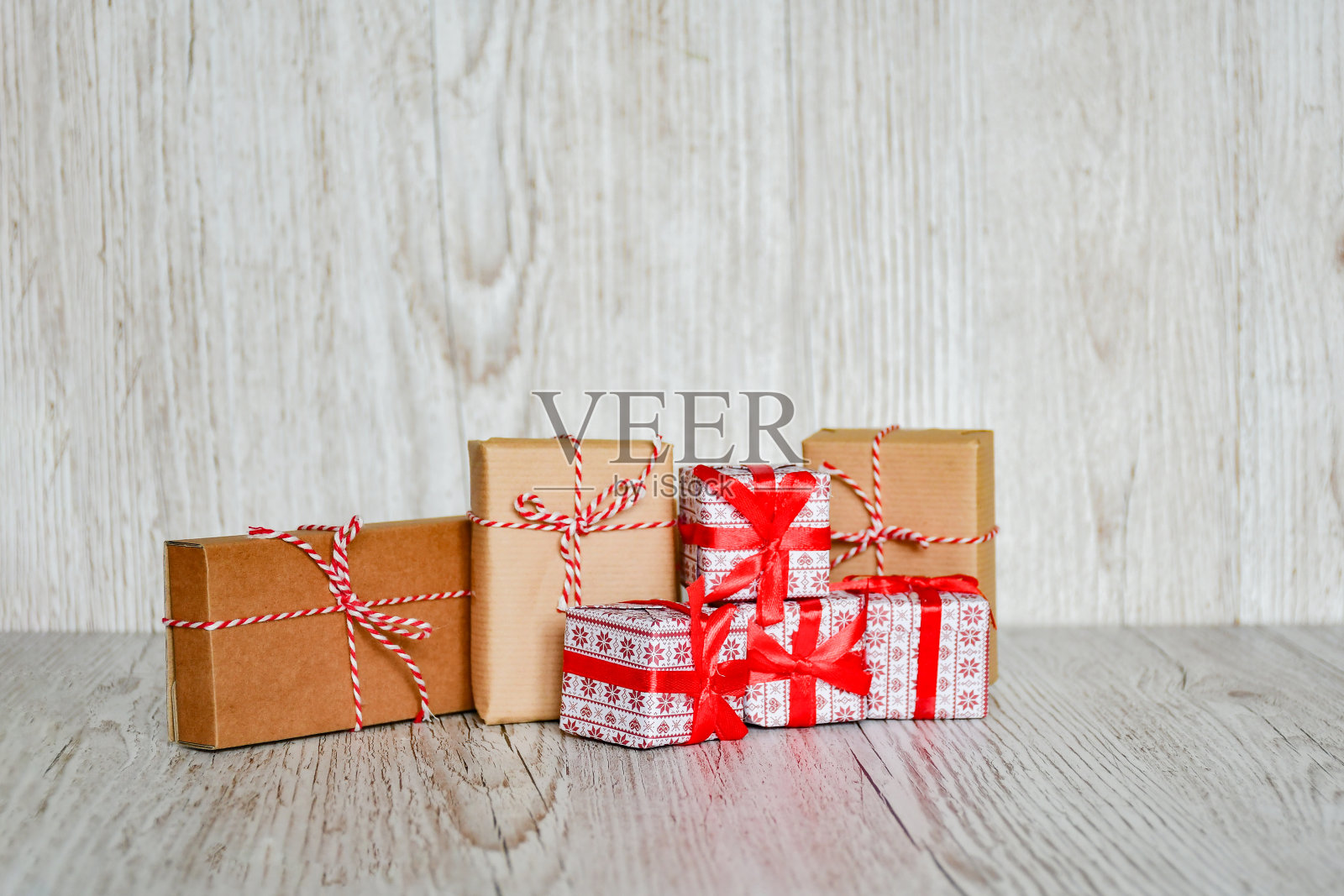 选择性的焦点套装礼品盒紧与红色的缎带，手工物体在木材灰色背景。圣诞假期的概念。照片摄影图片