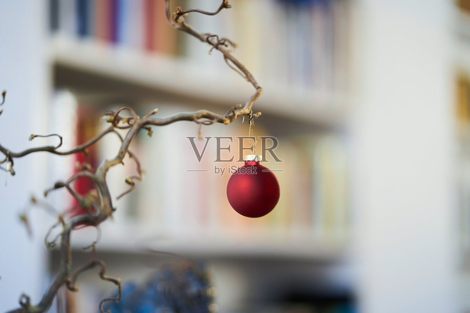 关闭的红色圣诞球在一个分支前不鲜明的背景书架照片摄影图片