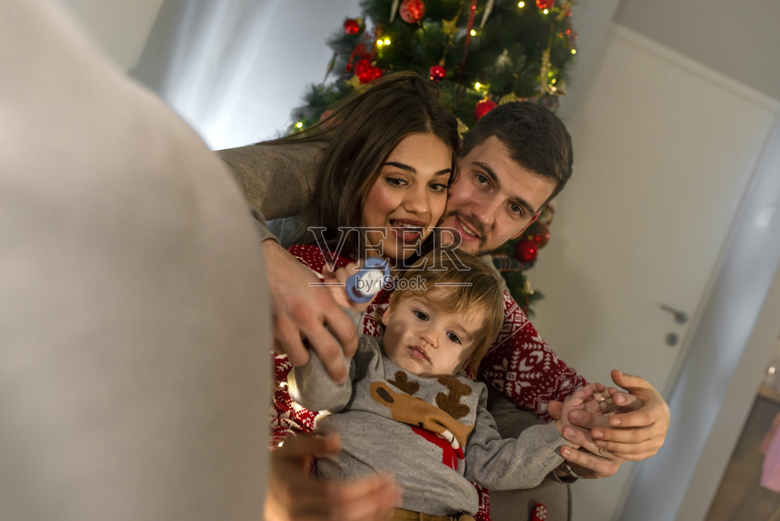 欢乐的一家人在家里享受平安夜。照片摄影图片