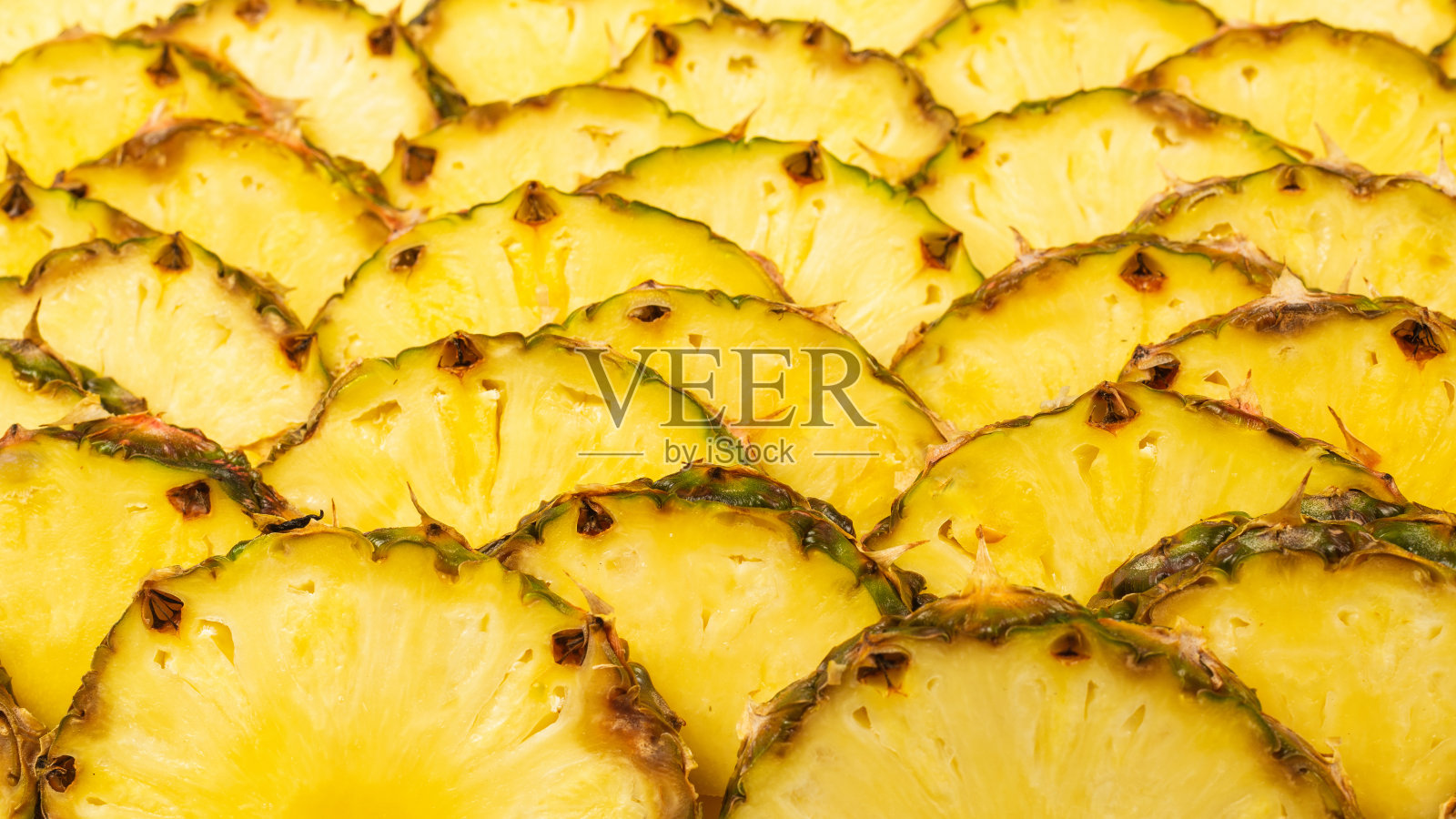 菠萝汁黄色切片背景。前视图。照片摄影图片