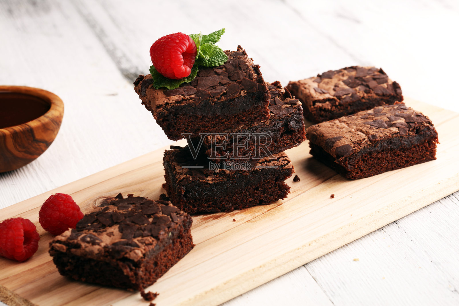 木背景上点缀着覆盆子和香料的巧克力布朗尼蛋糕甜点照片摄影图片