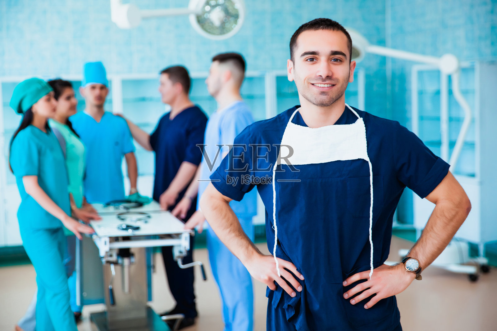 一个成功的专业医生的肖像。医学院的工作人员多国人员-医生，护士和外科医生。一群医科大学的毕业生在外科病房里。照片摄影图片