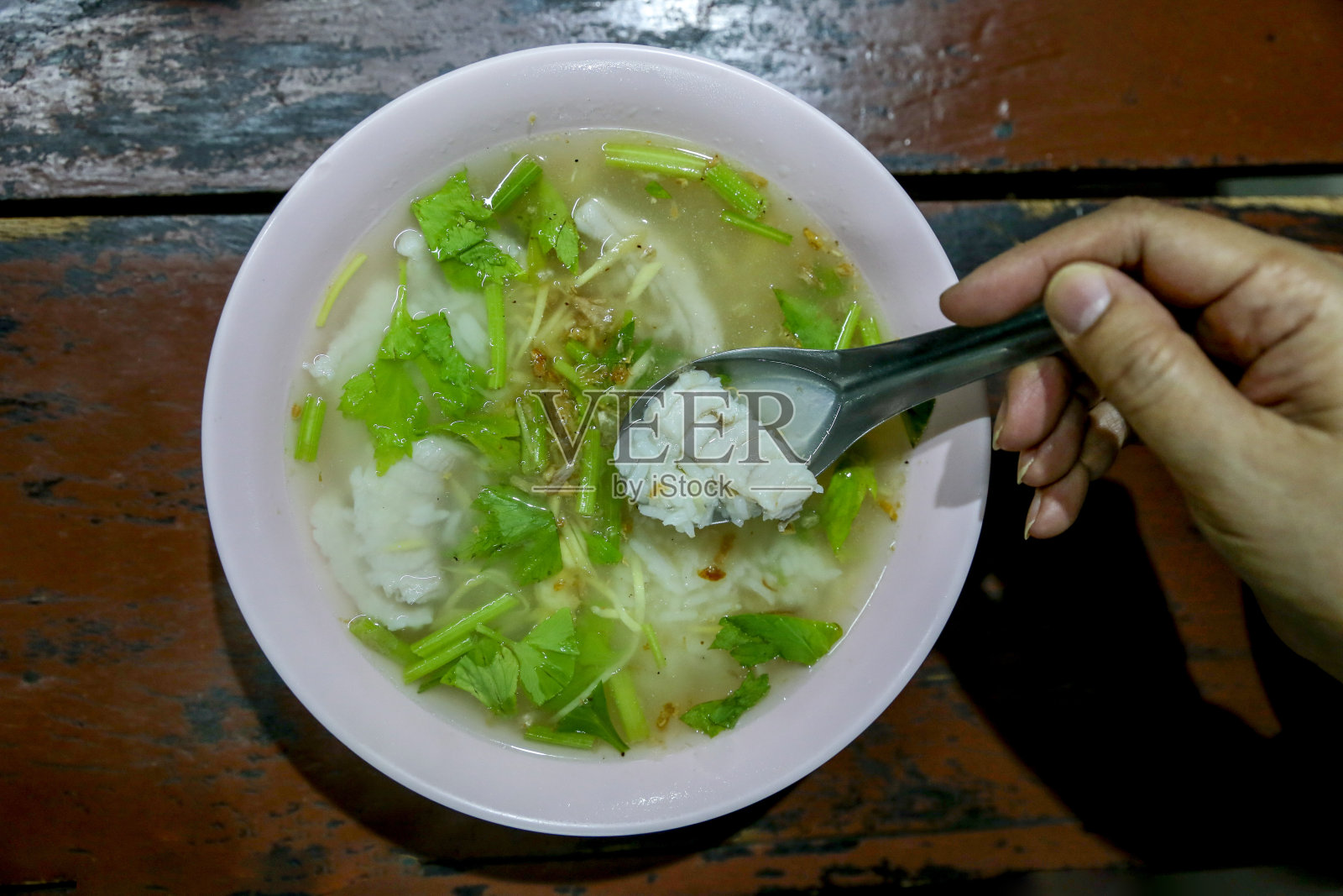 俯视图海鲈鱼粥与汤匙。照片摄影图片