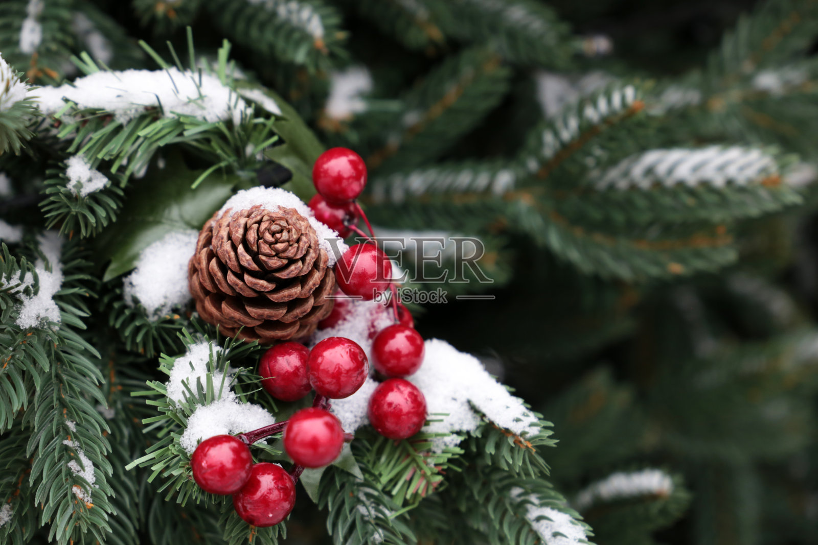 冬天街道上的冷杉树枝上被雪覆盖的圣诞装饰品照片摄影图片