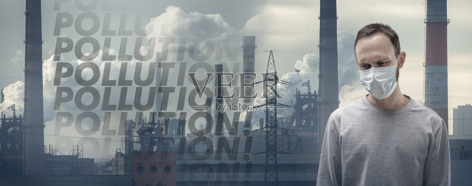 戴防雾霾口罩的白人男子，背景是工厂照片摄影图片