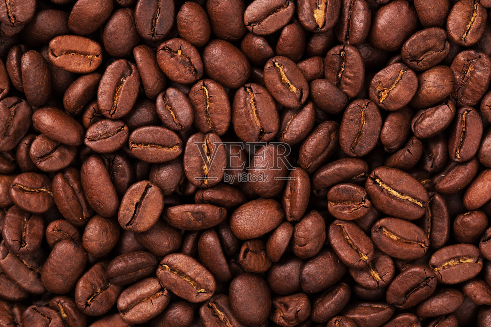 新鲜烘焙的咖啡豆特写。背景纹理照片摄影图片