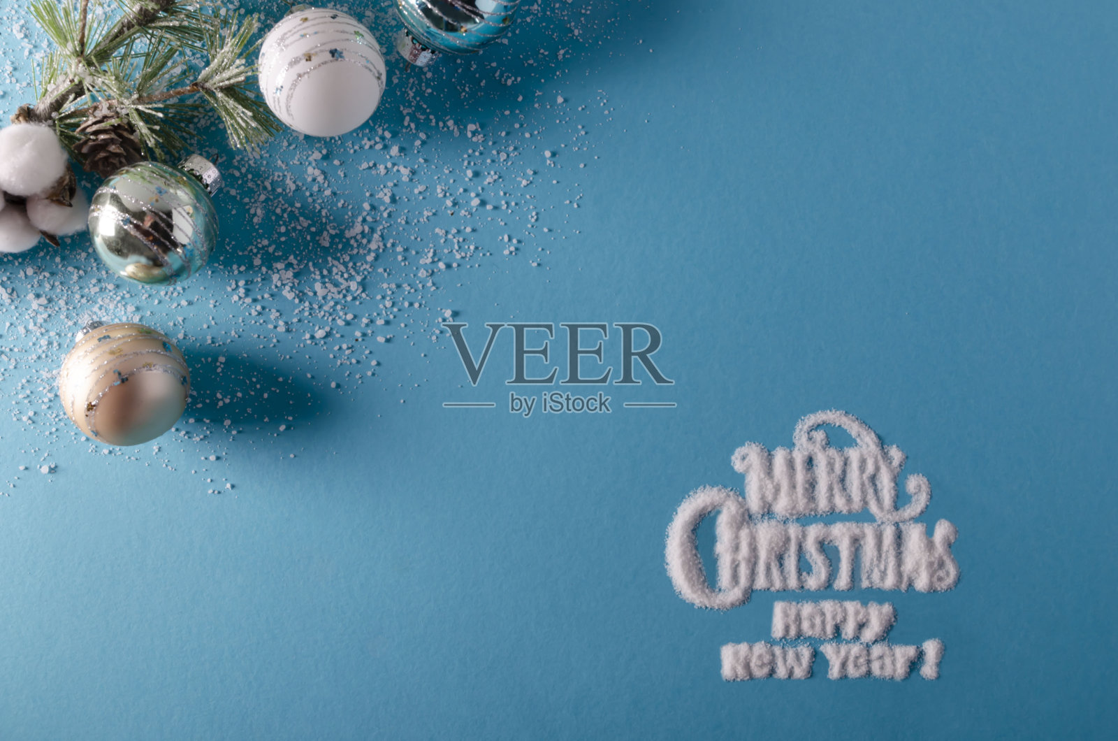 蓝色的假日季节背景与圣诞快乐和幸福的新年写在雪花照片摄影图片