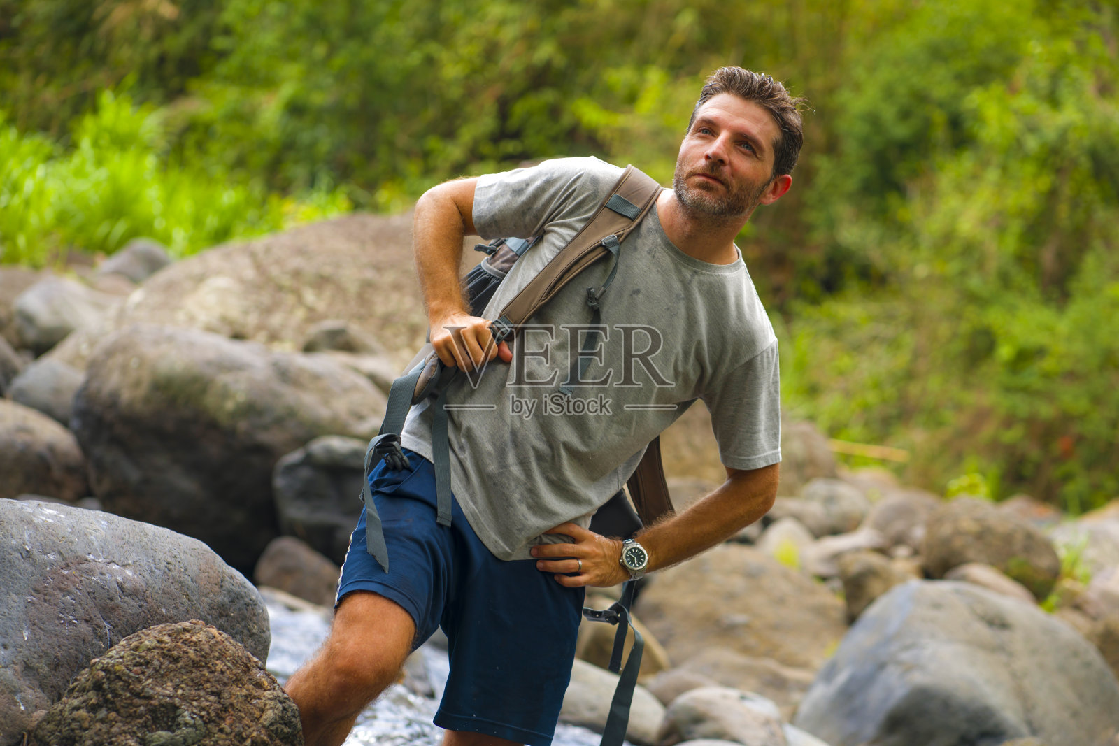 户外生活方式肖像的年轻快乐和有吸引力的男子旅行背包徒步在河在森林感觉自由享受自然和新鲜的环境在夏季徒步旅行照片摄影图片