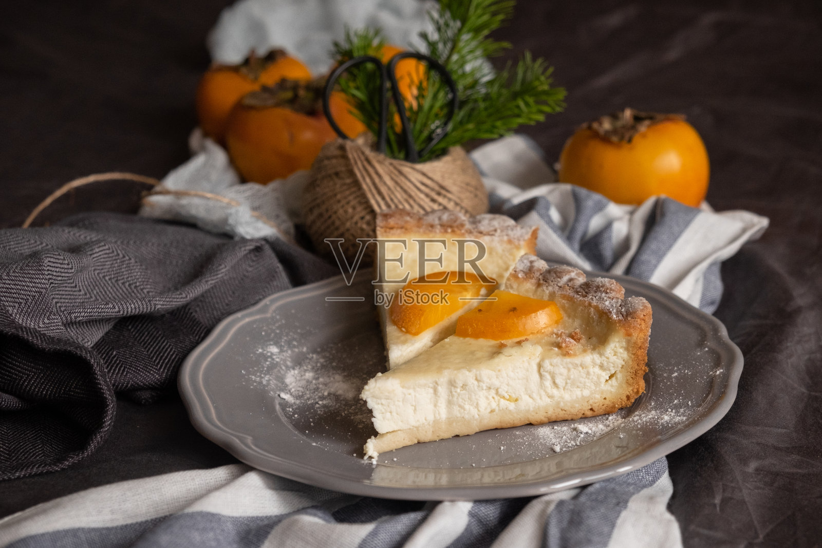 原来的柿子芝士蛋糕。灰色背景上漂亮的甜点。新年。圣诞节。万圣节的感恩节照片摄影图片