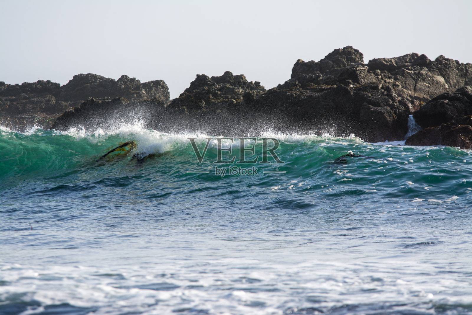 汹涌的海浪掠过嶙峋的海岸线照片摄影图片