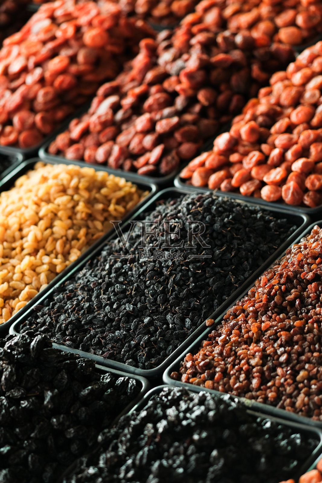 柜台上放着干果。葡萄干，杏干，西梅。素食照片摄影图片