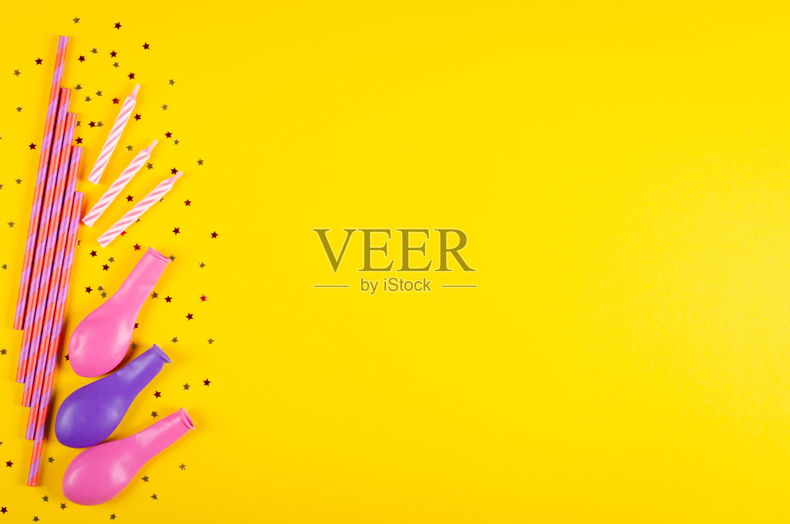 彩色的饮料吸管和气球组成在黄色的背景，聚会和庆祝装饰。照片摄影图片