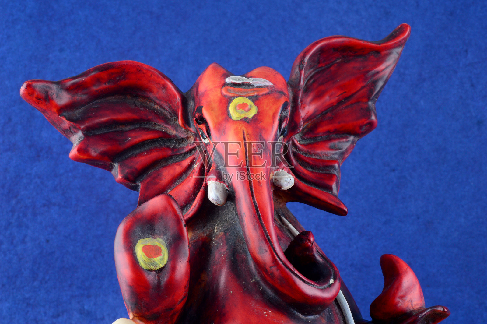 印度教神甘尼萨。甘尼萨偶像在蓝色背景照片摄影图片