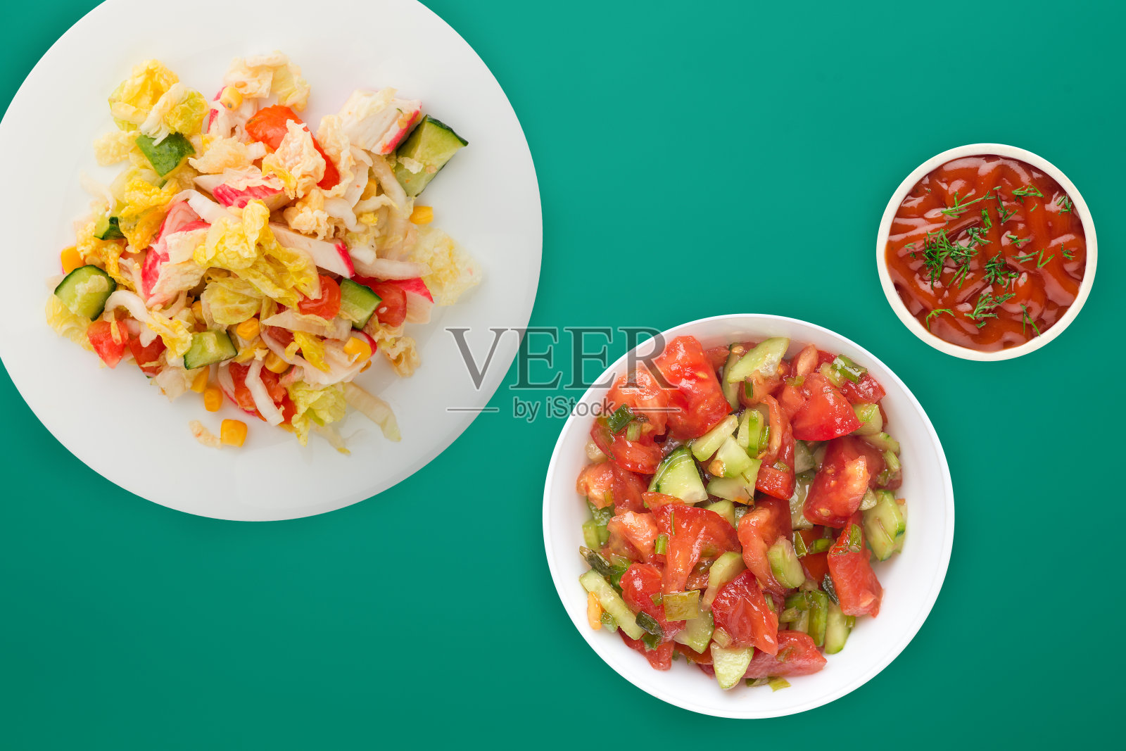 健康食品。吃素的人在一个白盘子里盘着盘子。蟹肉、黄瓜、玉米、番茄和生菜的彩色背景沙拉。照片摄影图片