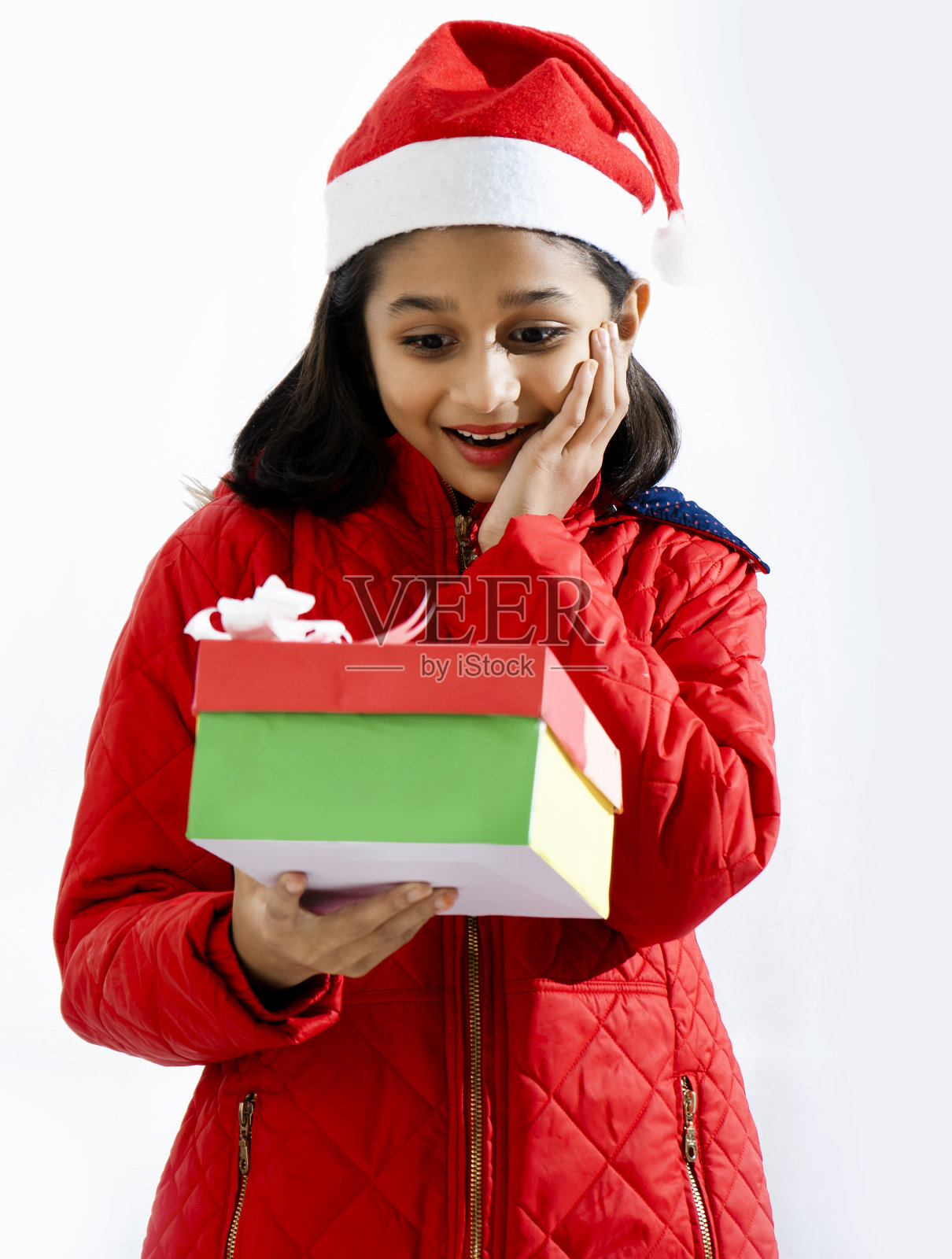 一个快乐的微笑小女孩的肖像与色彩满圣诞礼物盒照片摄影图片