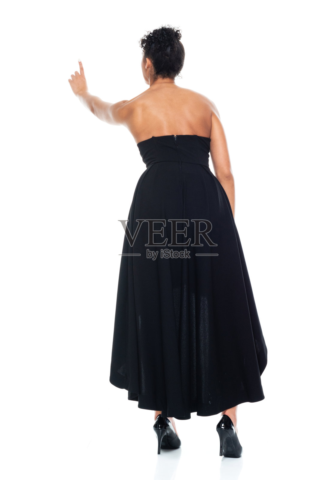 后视图/全长/一个20-29岁的成年人美丽的非洲裔/非洲裔女性/年轻女性穿着衣服/凉爽的态度和触摸谁是显示/指向照片摄影图片