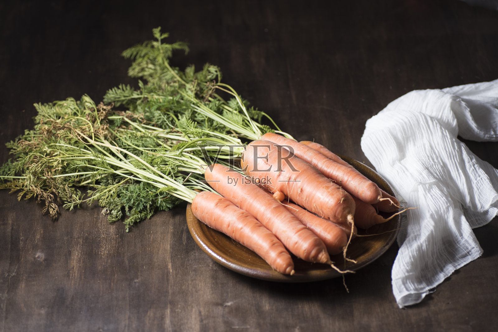 粘土盘上天然胡萝卜照片摄影图片