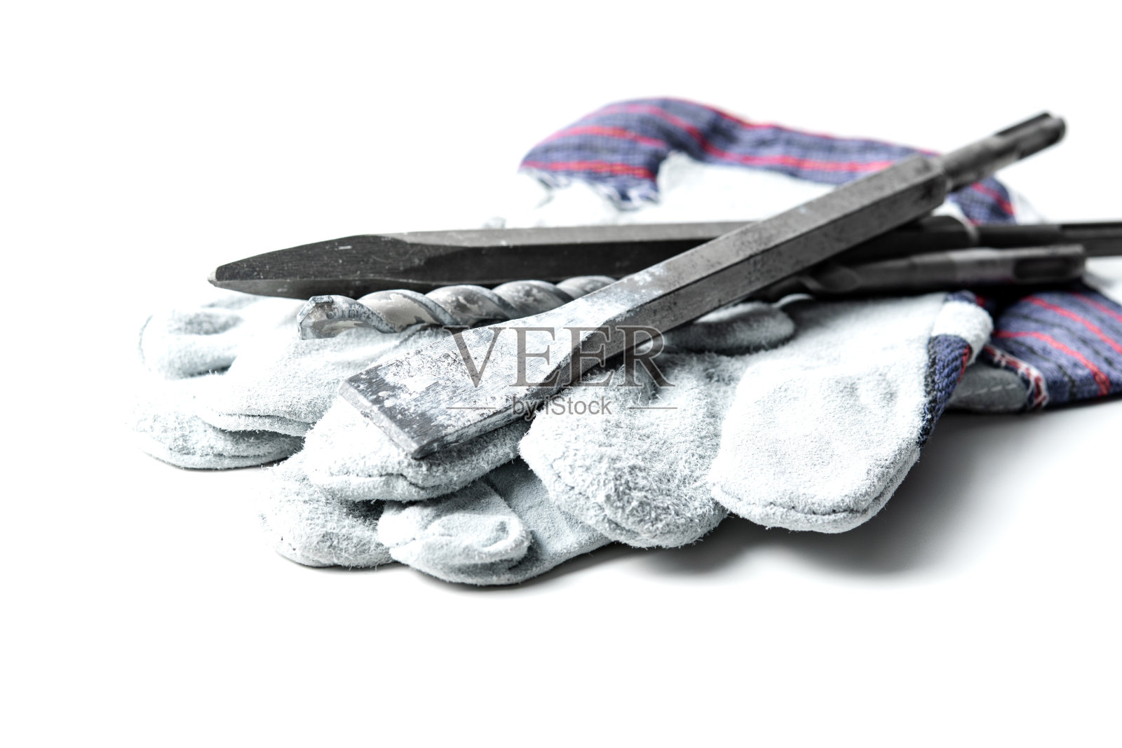 带手套的凿岩机在白色的表面上照片摄影图片