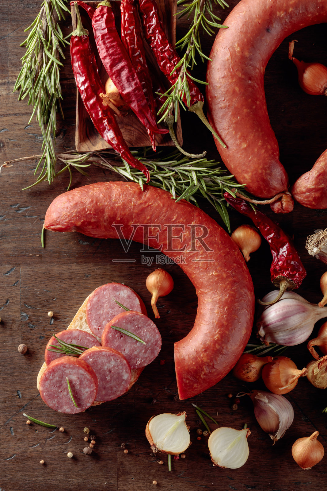 旧木桌上放着香肠三明治。照片摄影图片