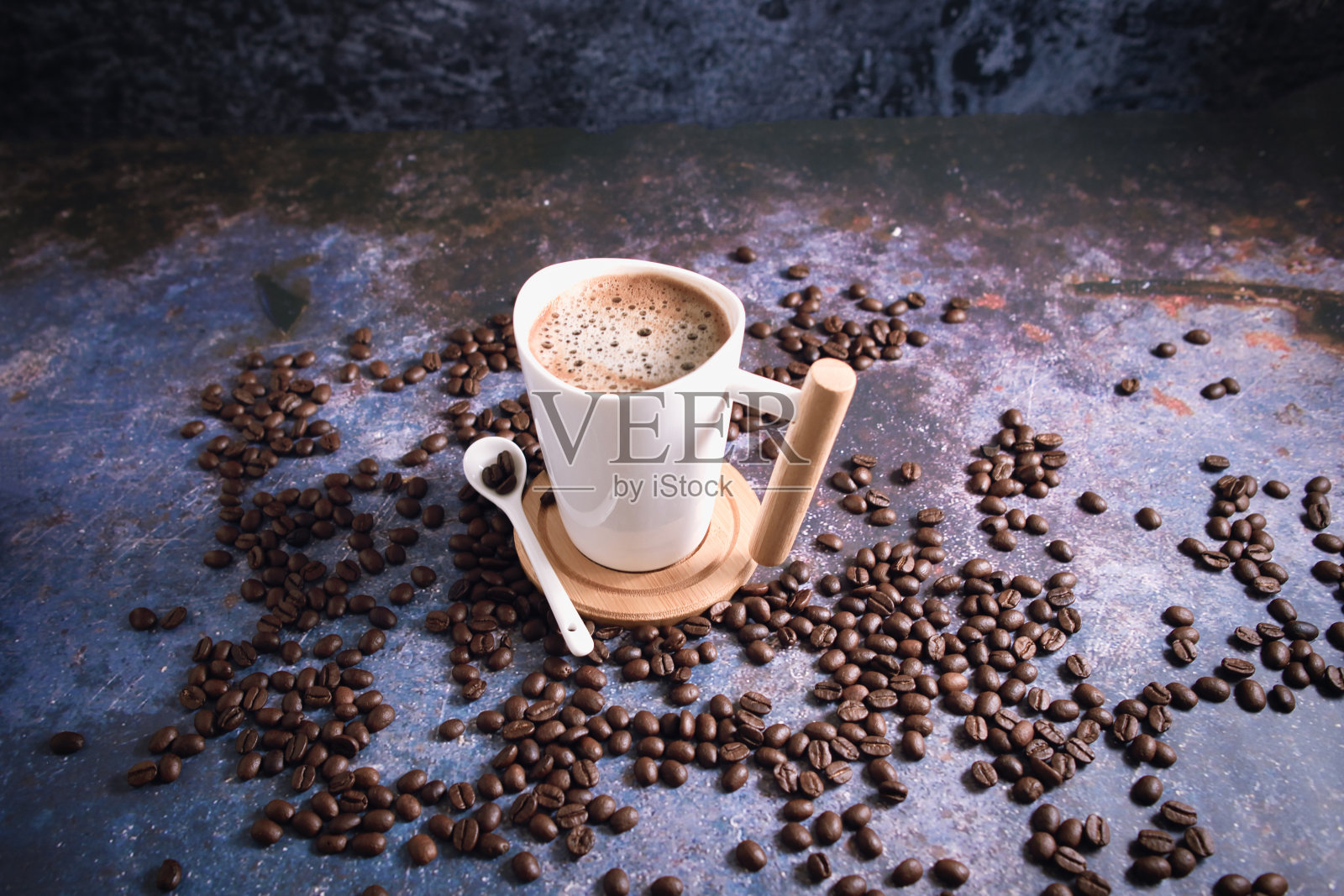 烤棕色的咖啡豆和热咖啡，质朴的桌子上的拿铁艺术。照片摄影图片