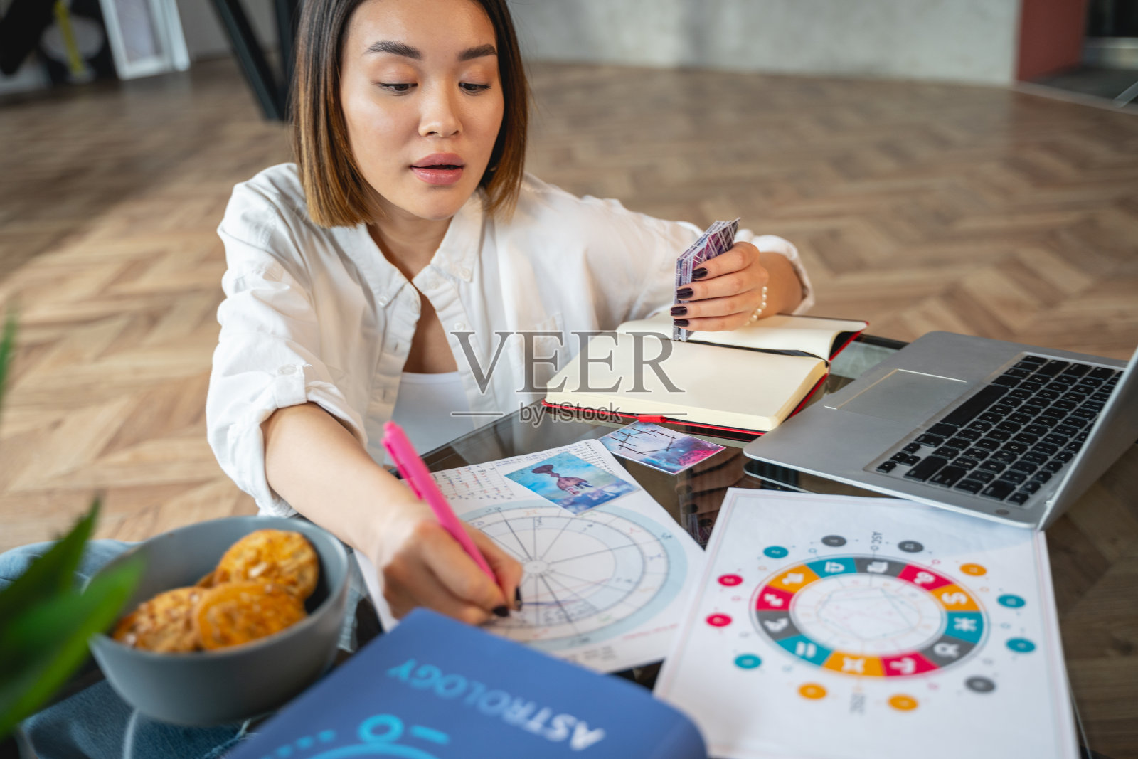 亚洲冷静的女孩在室内分析她的星座照片摄影图片