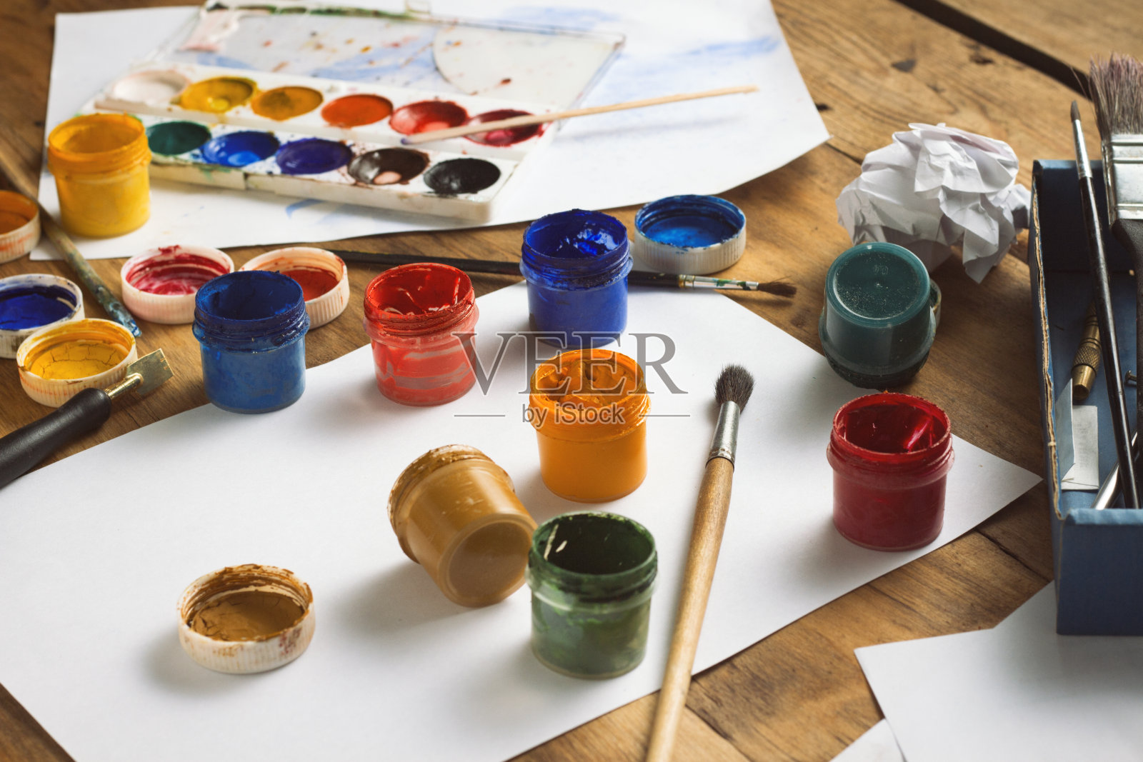 采购产品水彩画，水粉，刷子和纸在木制的背景上。艺术家的创意工作室的概念照片摄影图片