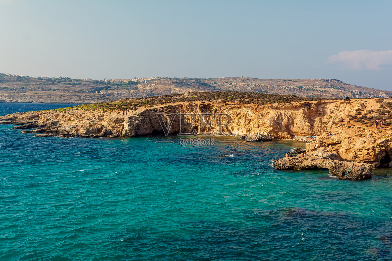 人们在蓝色泻湖的碧水中沐浴照片摄影图片