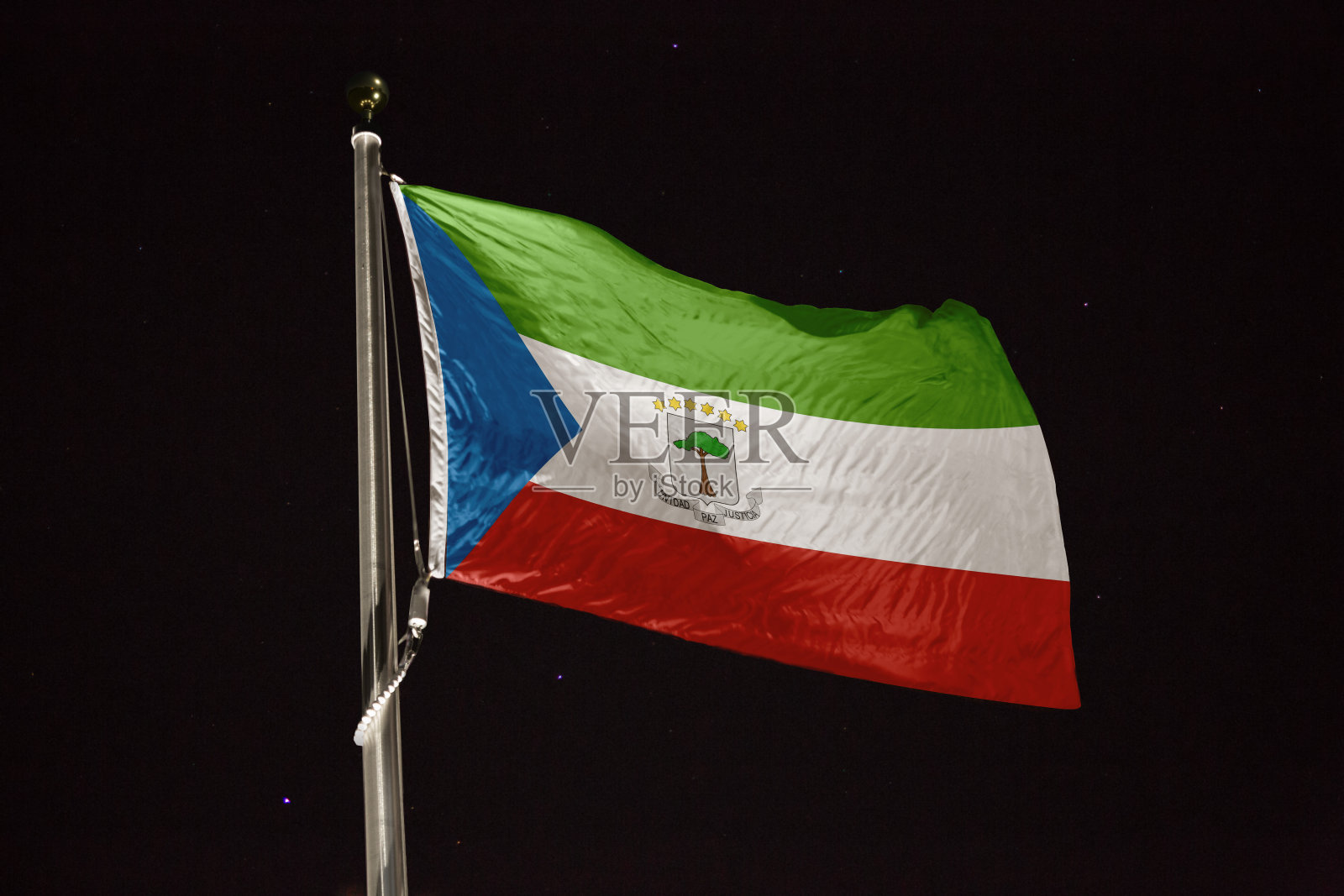 赤道几内亚的国旗在夜晚的风中飘扬照片摄影图片