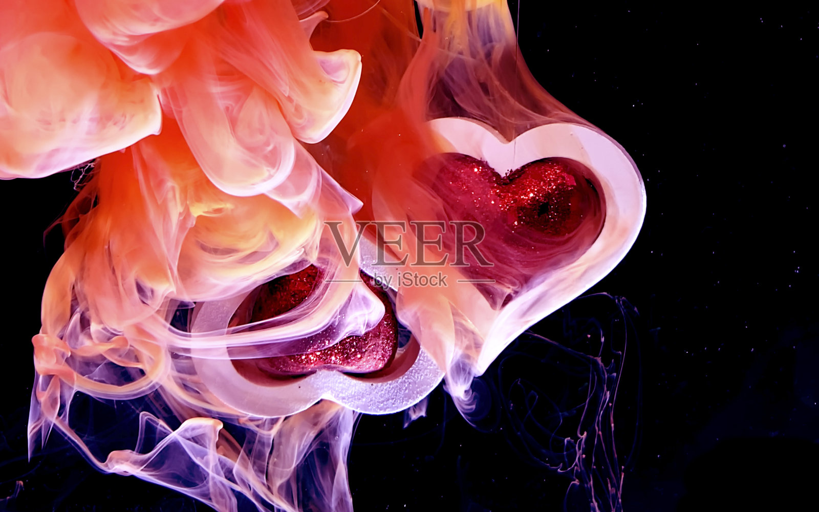 两颗白色的心和红色的心在一个美丽的火热的背景。照片摄影图片