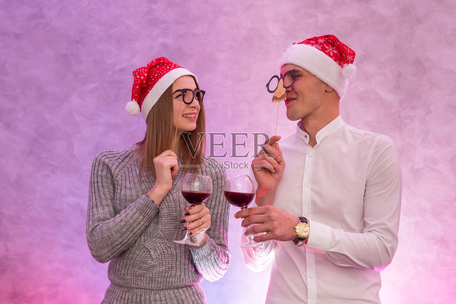 情侣戴圣诞帽，举杯庆祝情人节照片摄影图片