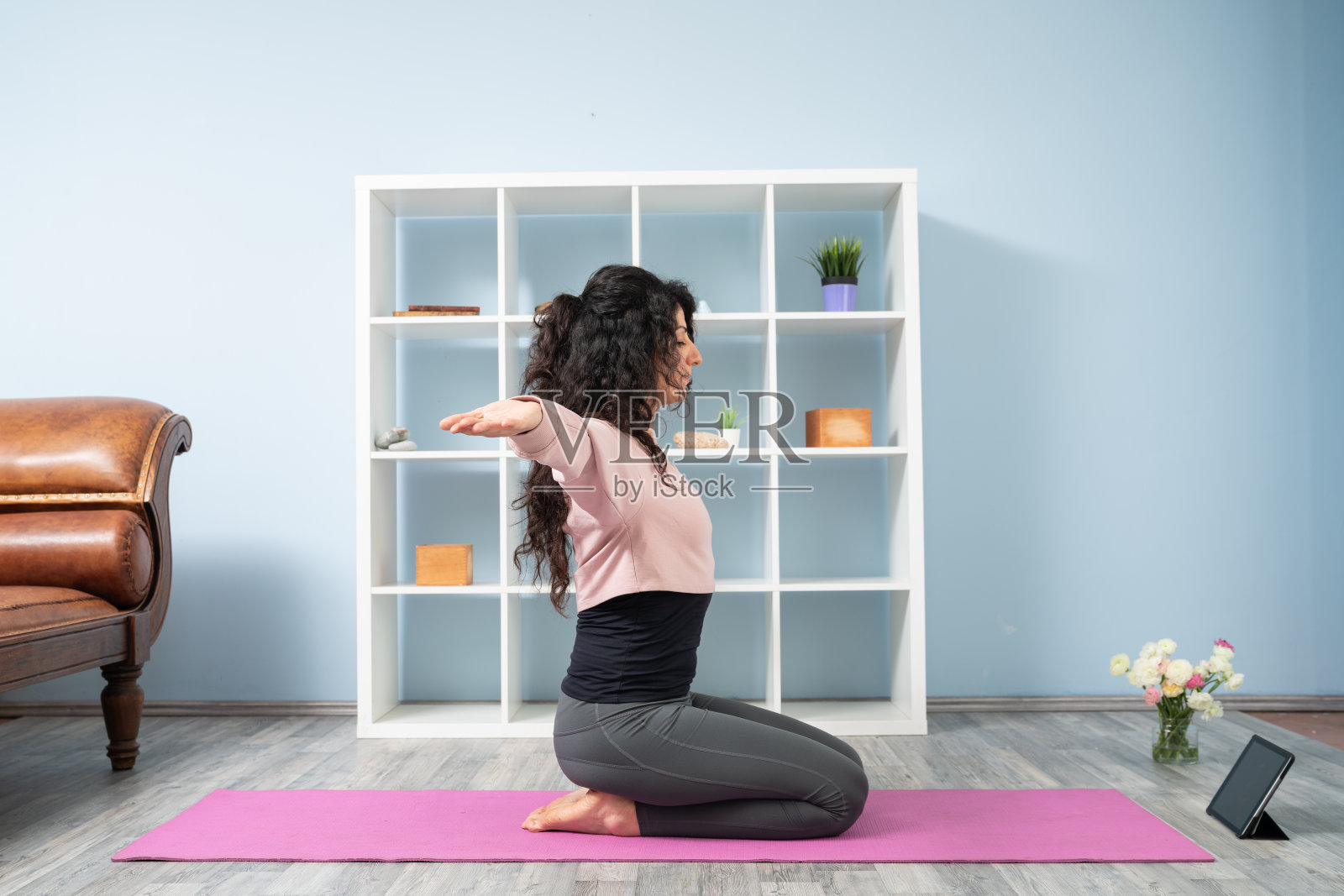 成年女性在客厅上网学习瑜伽照片摄影图片