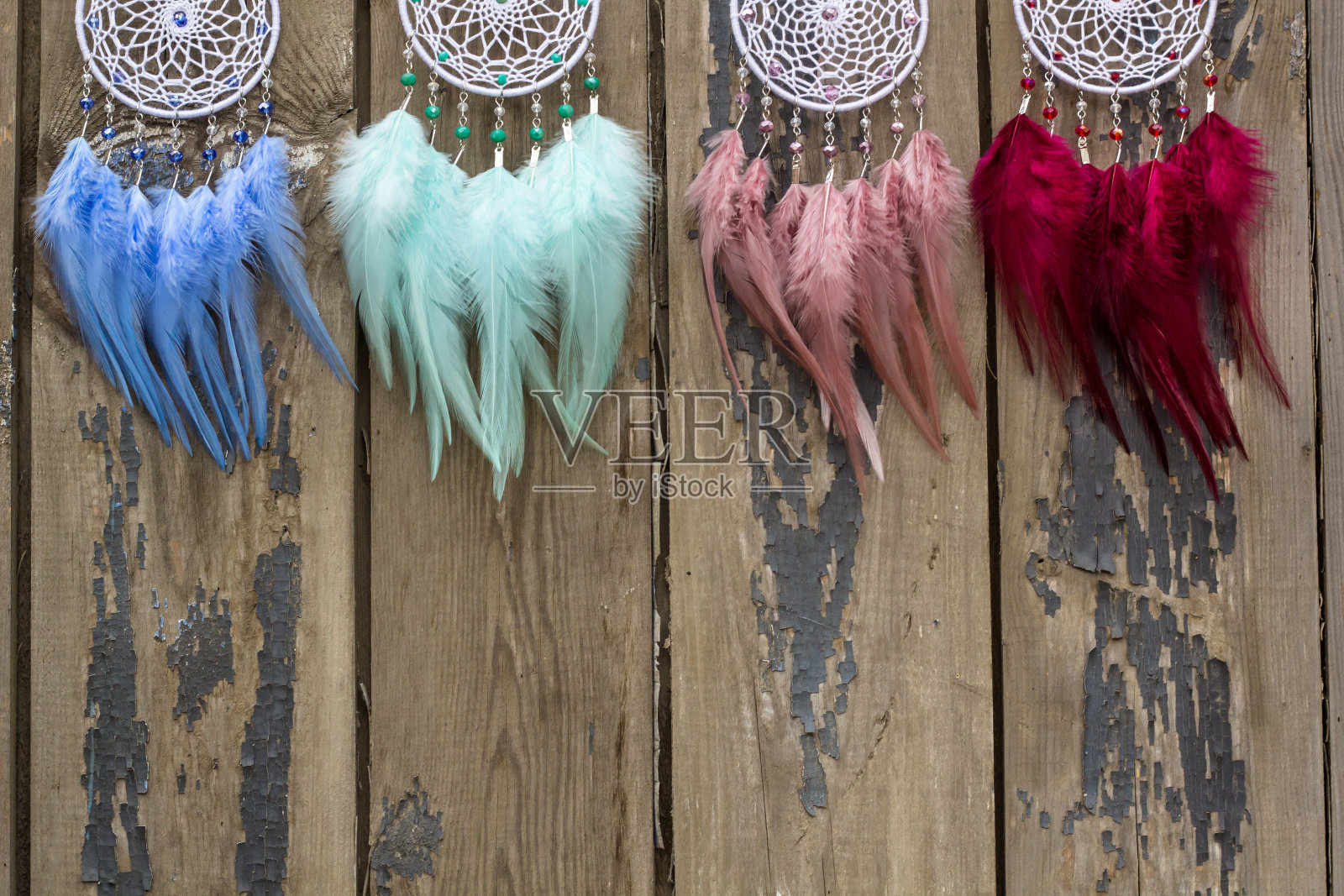 许多手工捕梦网用羽毛、线和珠子绳挂着照片摄影图片