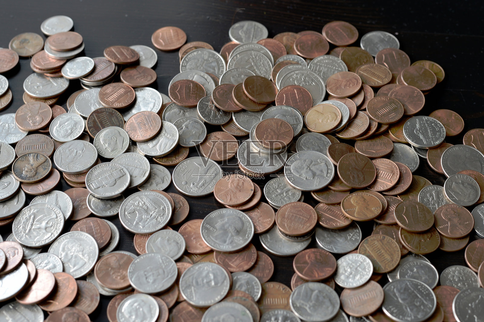 堆放在黑色木质表面的美国分币照片摄影图片