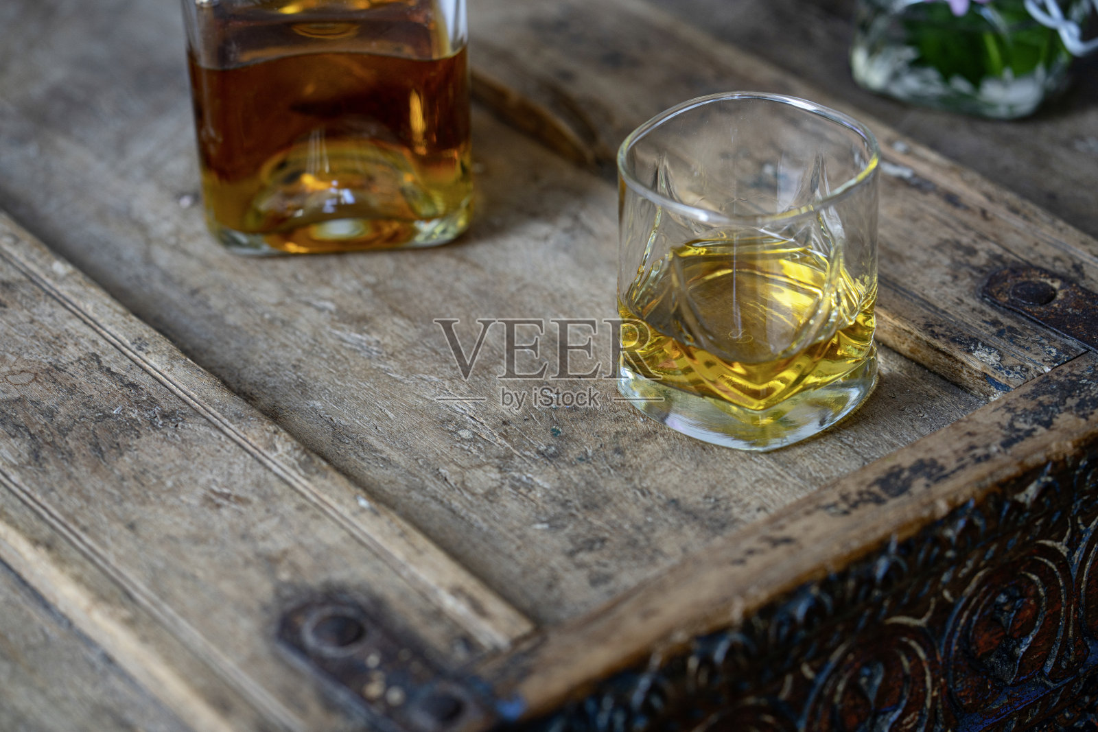 威士忌玻璃杯和瓶子与金色闪烁的苏格兰威士忌在棕色使用破旧的单一麦芽木木质爱尔兰橡木干邑朗姆酒白兰地照片摄影图片