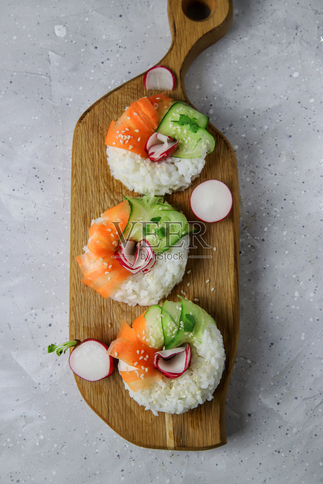 时髦的亚洲食物-寿司甜甜圈配新鲜蔬菜。素食主义者和素食主义者的当代小吃照片摄影图片