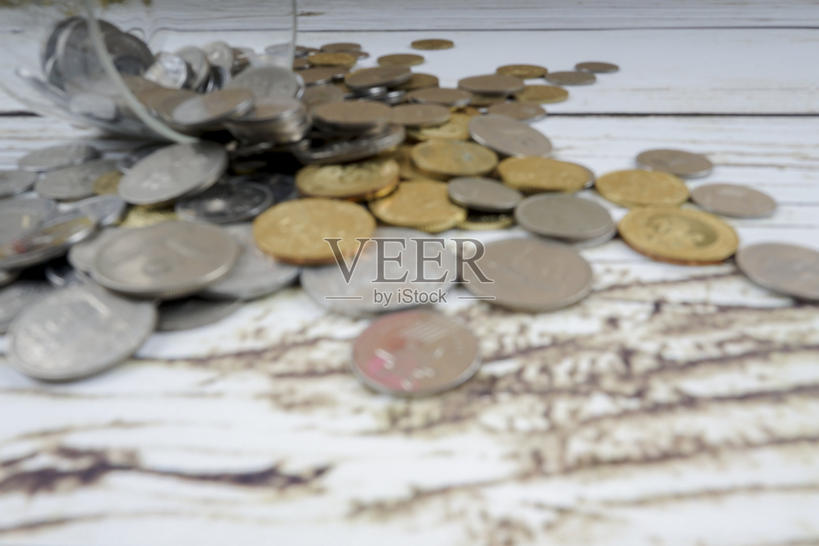 木制背景上有硬币的玻璃罐子照片摄影图片