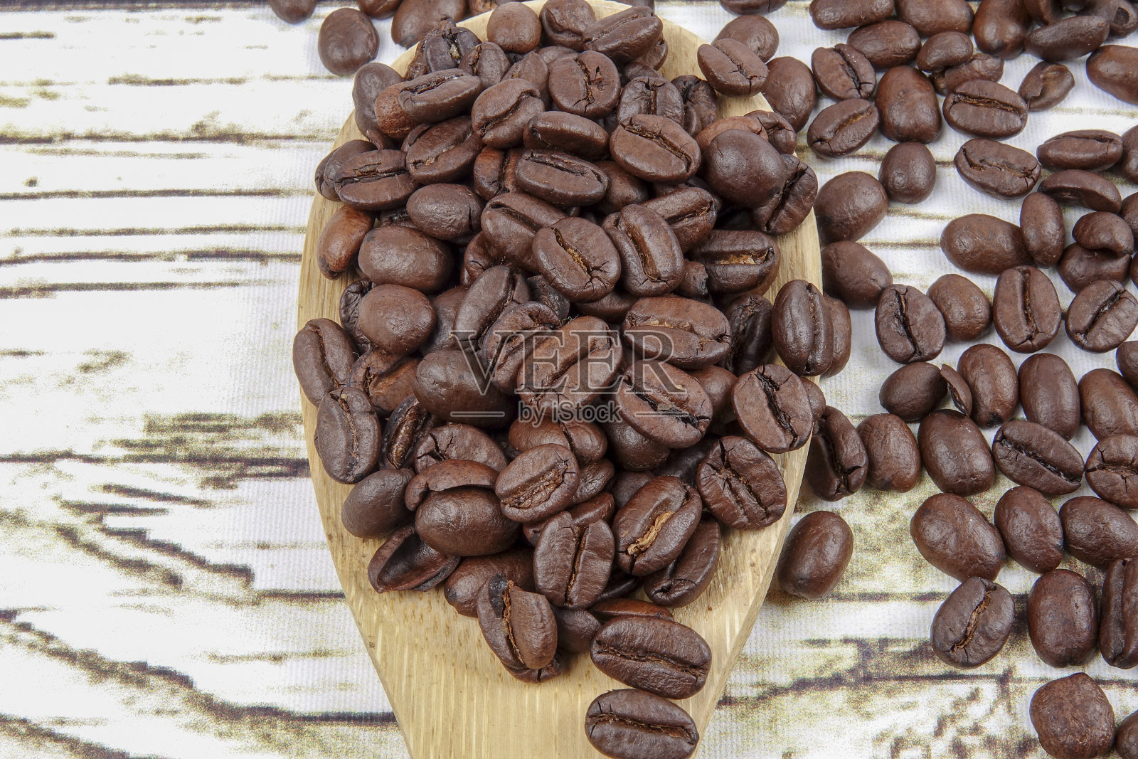 生锈的背景上放着咖啡豆和木勺照片摄影图片