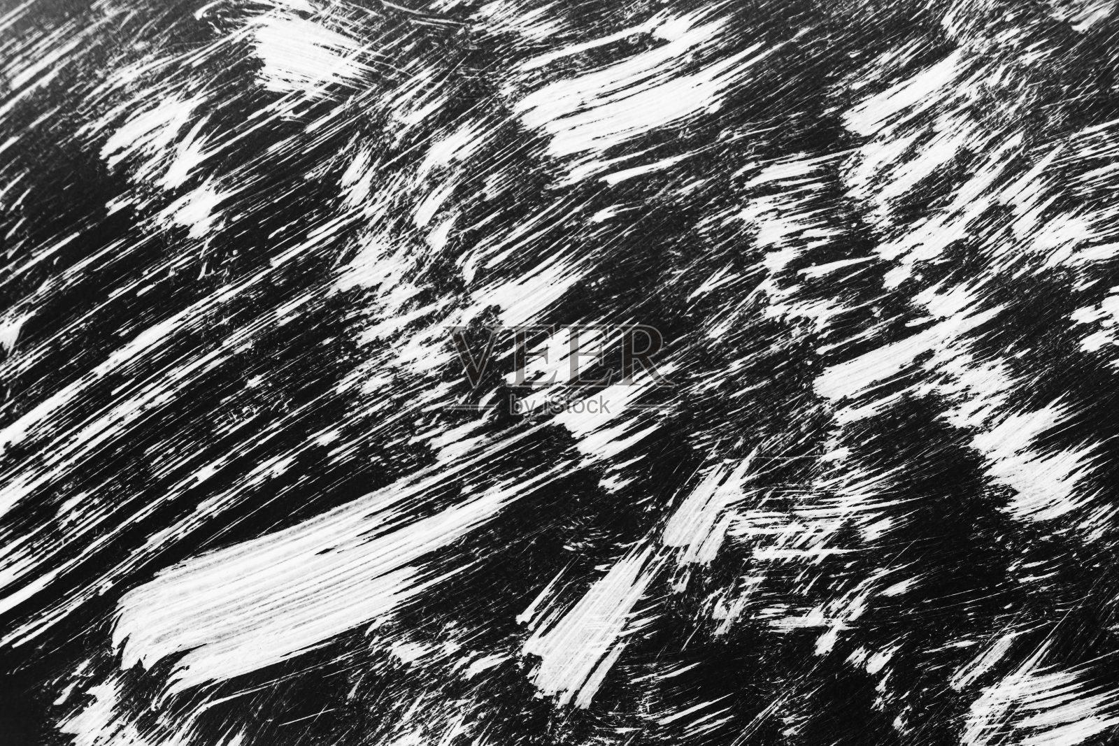 用画笔在黑色背景上画出的白色图案照片摄影图片