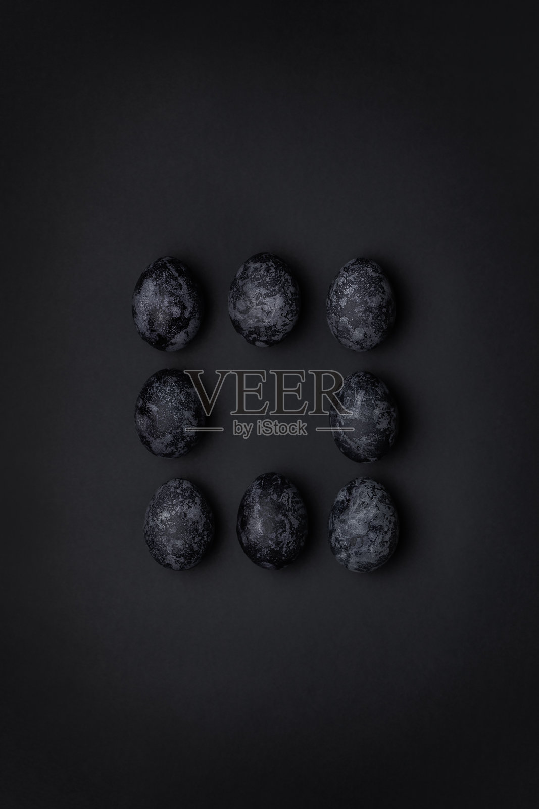 手工制作的单色黑色纹理画鸡蛋方形图案在中间的构图上的黑色背景照片摄影图片