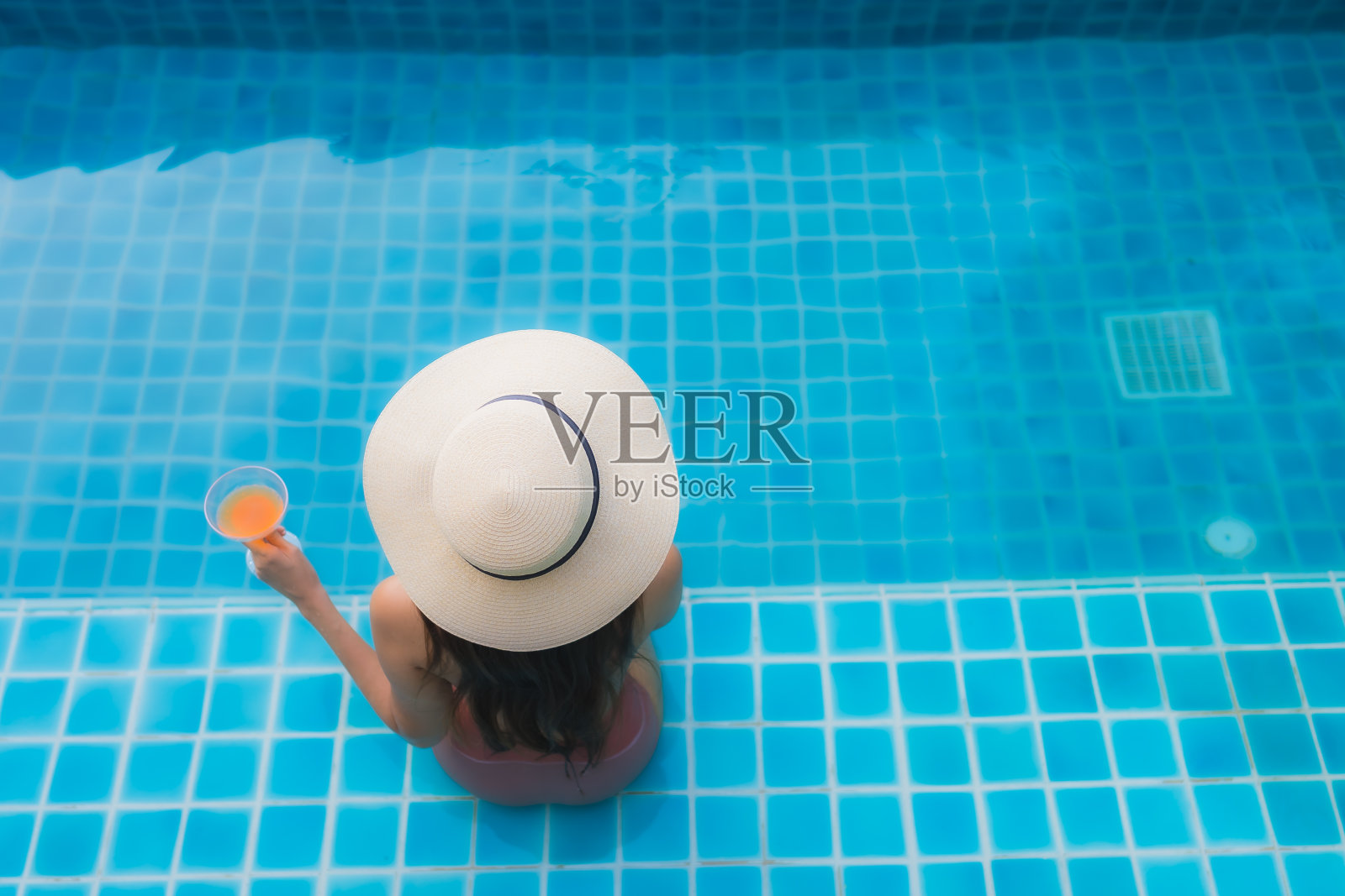 在酒店游泳池旁放松微笑的年轻亚洲女子肖像照片摄影图片