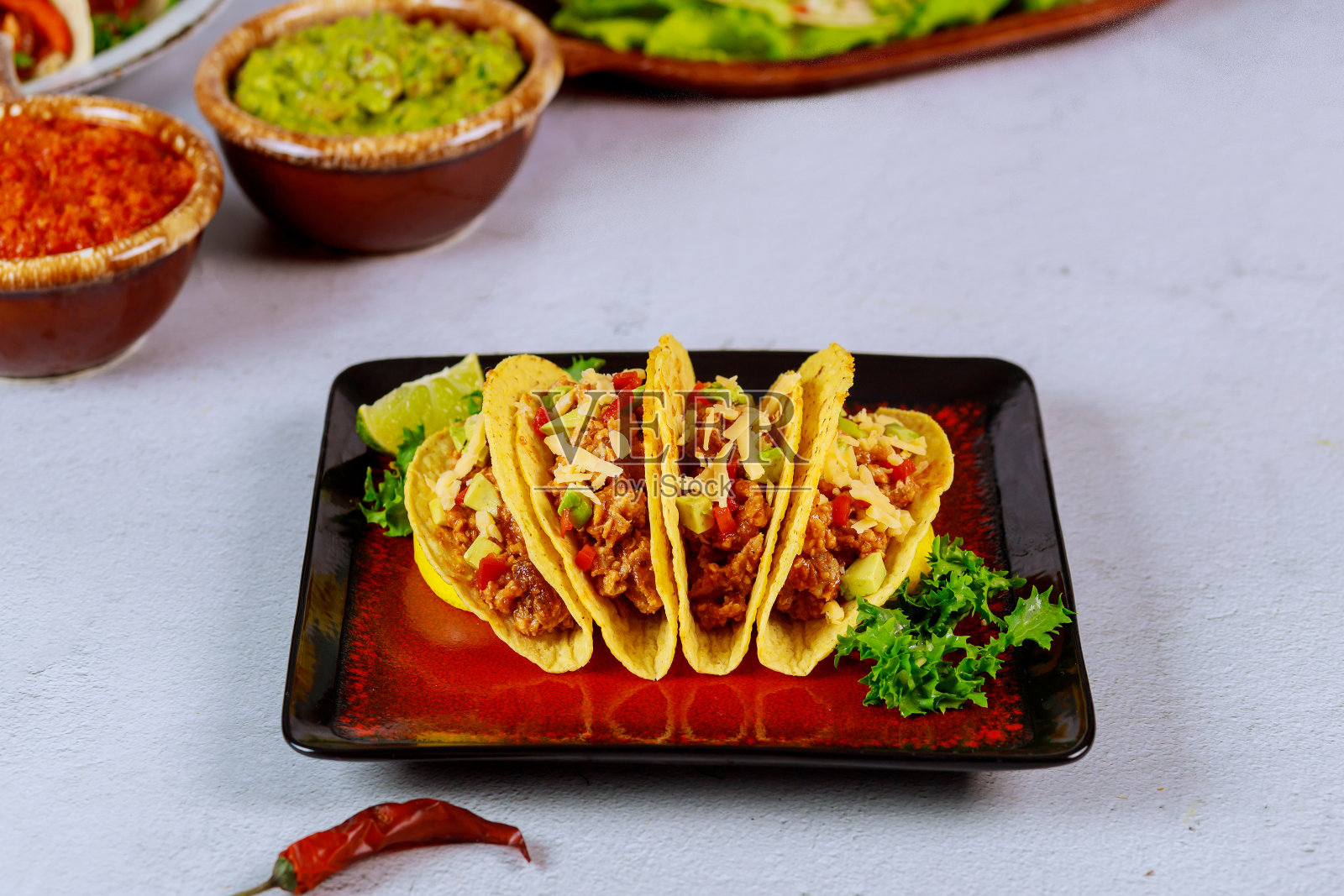 填充玉米卷壳，莎莎酱和鳄梨酱，墨西哥菜玉米饼。照片摄影图片