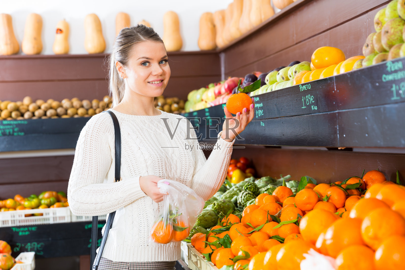 在食品店选择水果的女孩照片摄影图片