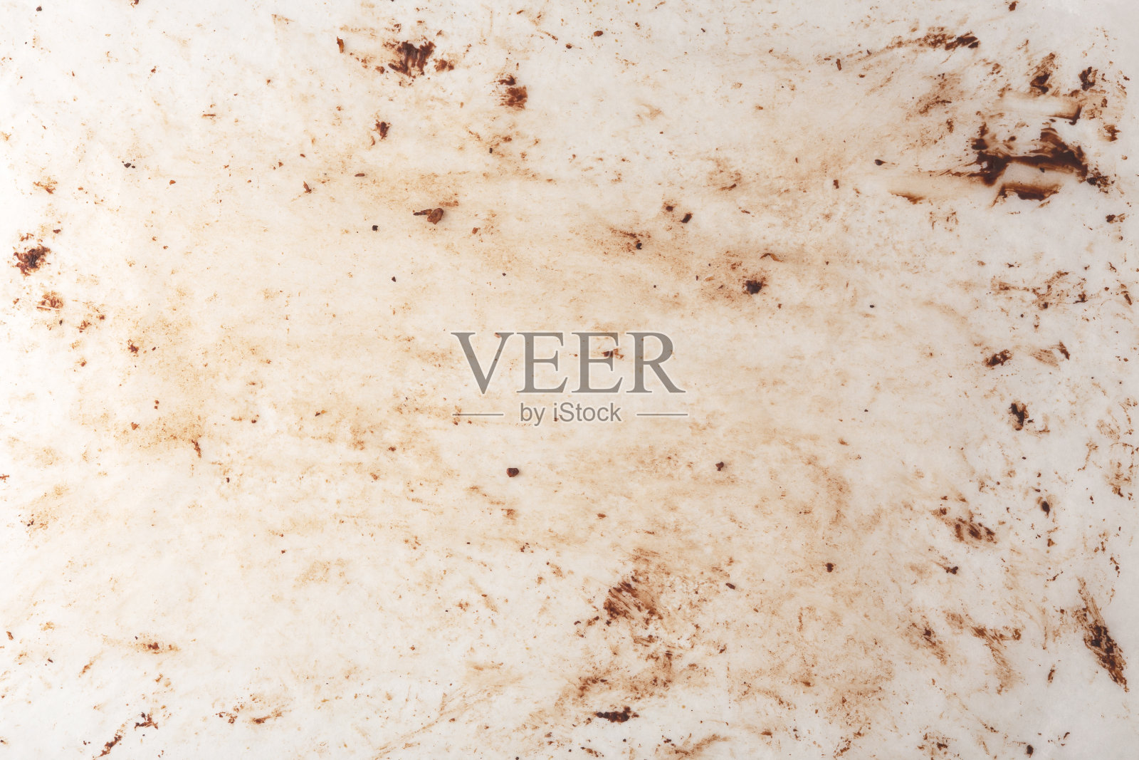 烘焙纸上有巧克力污渍，质地和背景照片摄影图片