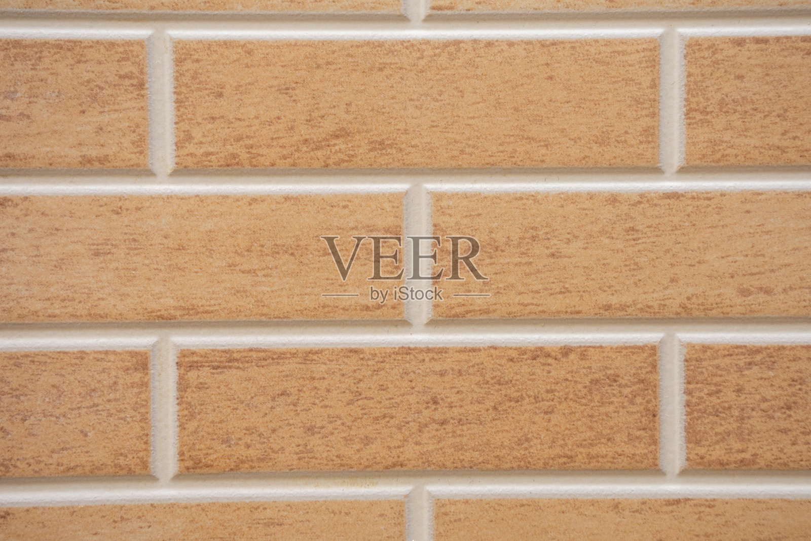 米色纹理砖室内或室外墙壁，白色灌浆。室内设计、施工、DIY或建筑的概念或背景。照片摄影图片