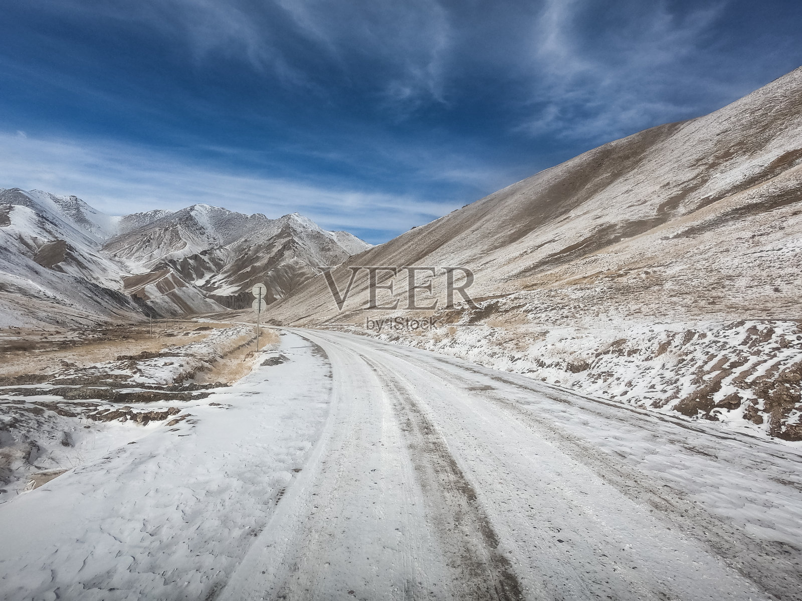 砾石路在干燥的土地上与雪山照片摄影图片