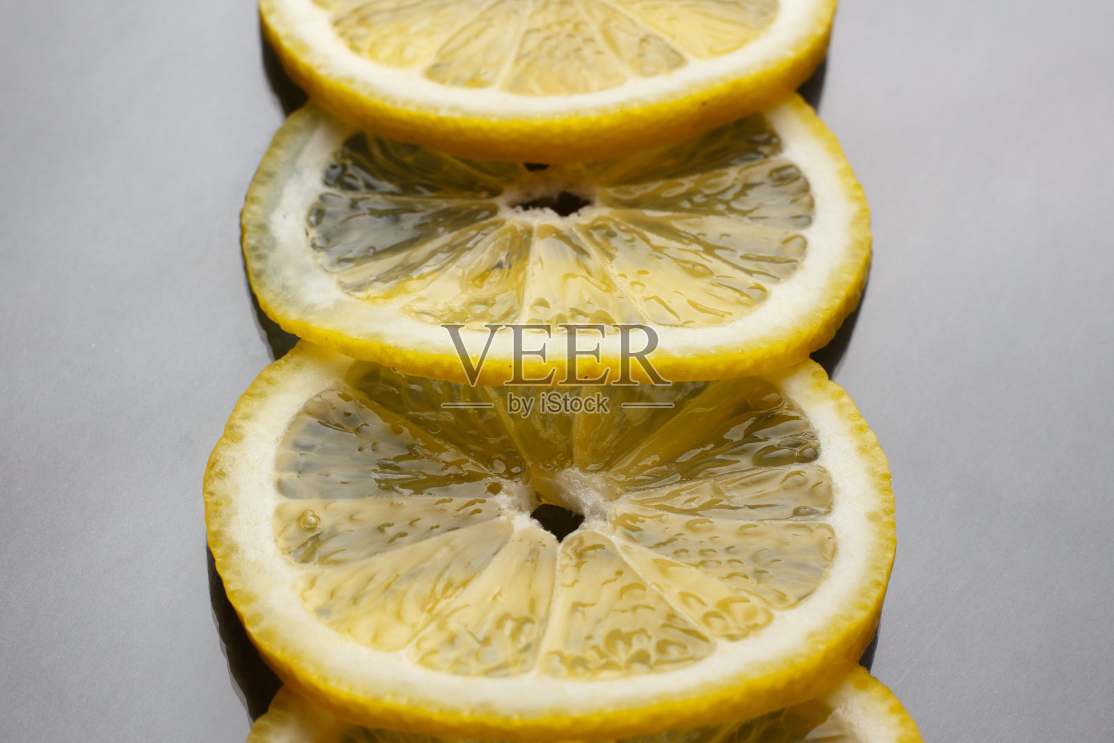 新鲜多汁的柠檬片在黑色的背景上。照片摄影图片