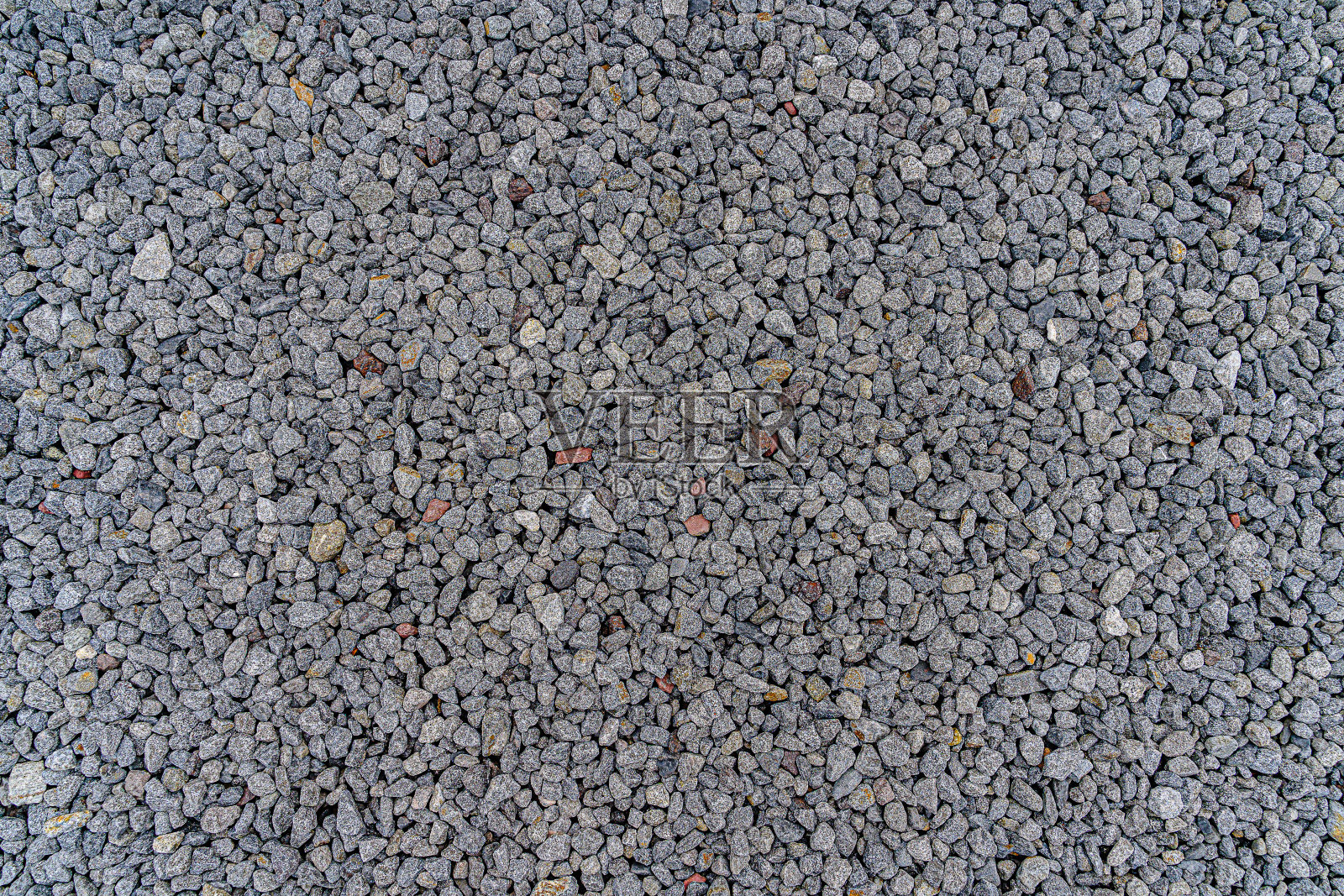 作为花园装饰中的人行道的砾石图像的背景是许多建筑的混合。它是一个重要的土壤，可以装饰漂亮。照片摄影图片