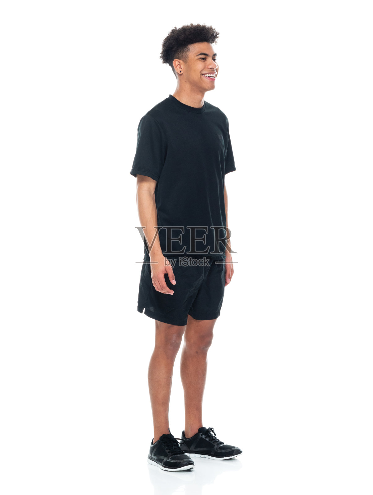 穿着运动服装站在白色背景前的非裔美国青少年男孩照片摄影图片