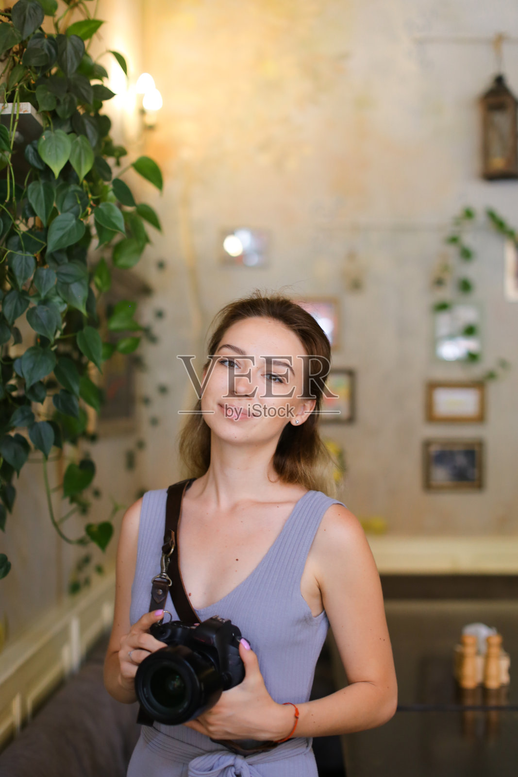 站在咖啡馆拿着照相机的女人肖像照片摄影图片