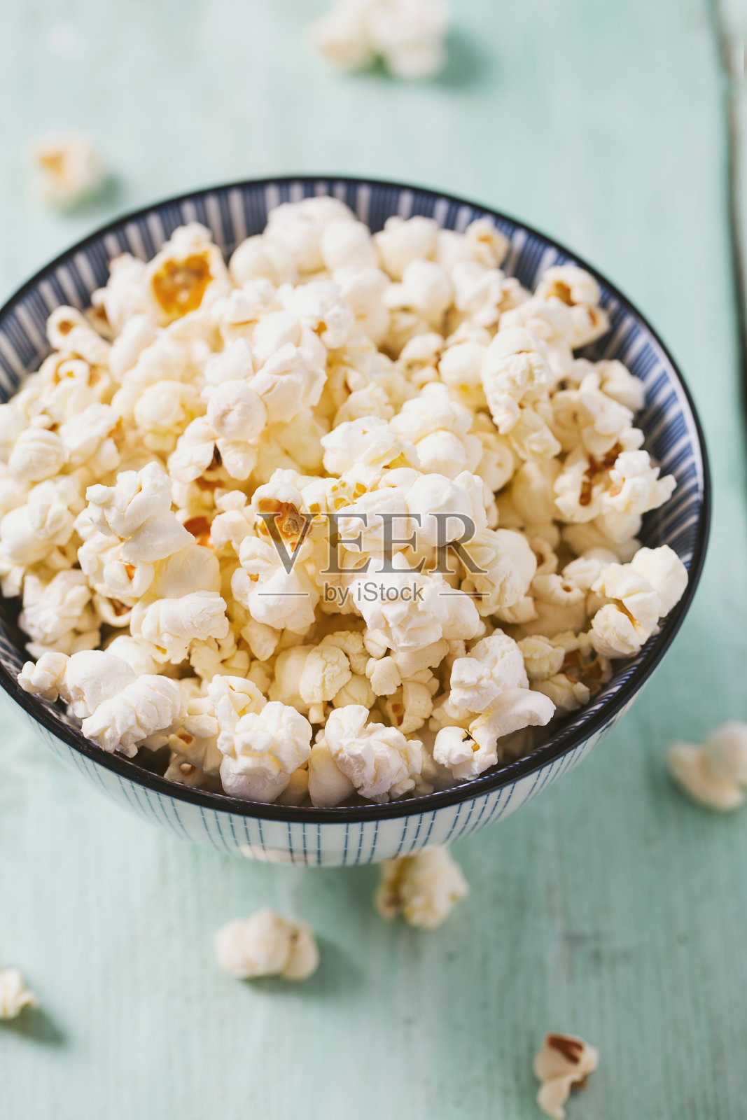 绿松石木质表面上的咸爆米花照片摄影图片